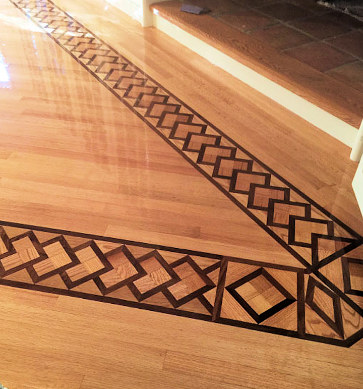 Intricate red oak floor with wooden tile border